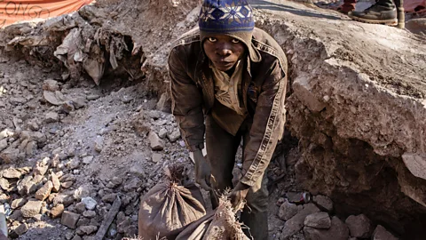Getty Images Mining for metals like cobalt from the ground is a dangerous and dirty job, often in countries far away from the electrical devices it is used in are bought (Credit: Getty Images)
