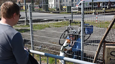 Noele Illien Since the coronavirus pandemic, Rohde and Brassel meet several times a week at the newly closed Swiss-German border along with their dog, Niro (Credit: Noele Illien)