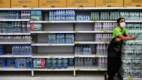 Getty Images If we see people panic buying goods - like bottled water, for instance - it can force us to behave similarly (Credit: Getty Images)