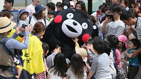 Jiji Press/Getty Images Following the 2016 Kumamoto earthquake, the mascot Kumamon brought great comfort to some Japanese at a time of pain and uncertainty (Credit: Jiji Press/Getty Images)