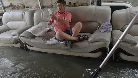 Barcroft Media/Getty Images The Chinese have a long history of smiling through the sorrow of natural and man-made disasters (Credit: Barcroft Media/Getty Images)
