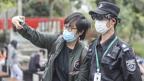 STR/Getty Images The neighbourhood watchmen tasked with enforcing China's lockdown have become the target of many jokes on Chinese social media (Credit: STR/Getty Images)