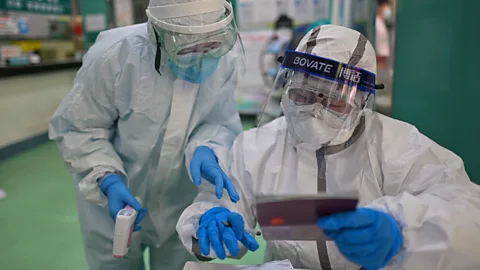 Getty Images A single droplet being tested can contain a million viruses, making it crucial that medical professionals wear full protective gear (Credit: Getty Images)