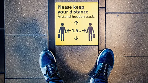 Getty Images Airports have installed signs urging social distance, like at Schiphol airport in the Netherlands (Credit: Getty Images)