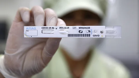 Getty Images An employee holds up a Covid-19 testing kit in Chuncheon, South Korea (Credit: Getty Images)