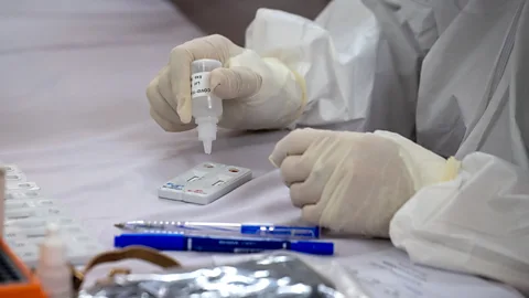 Getty Images A medical specialist tests blood samples for Covid-19 in Hanoi, Vietnam (Credit: Getty Images)