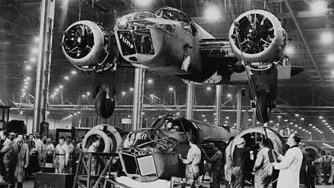 Getty Images During World War Two, factories which had once made cars were quickly reorganised to make weapons such as these British bombers (Credit: Getty Images)