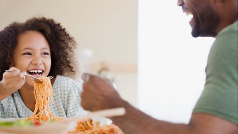 Father and daughter eating