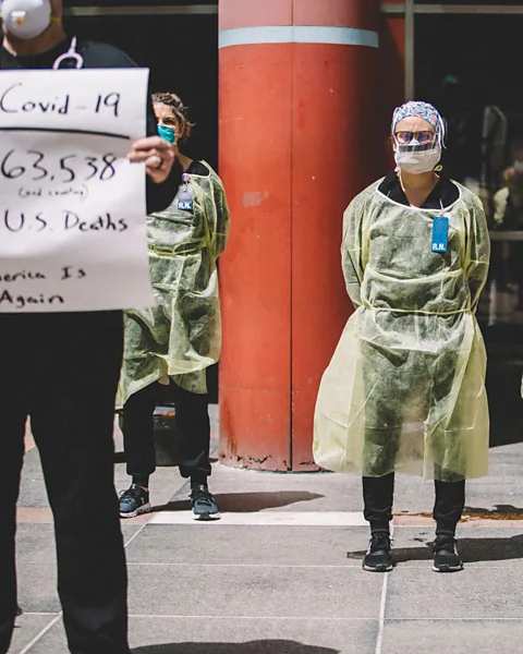 Getty Images Nurses in PPE have started standing in front of crowds during recent rallies in the US as a way of challenging their protests (Credit: Getty Images)