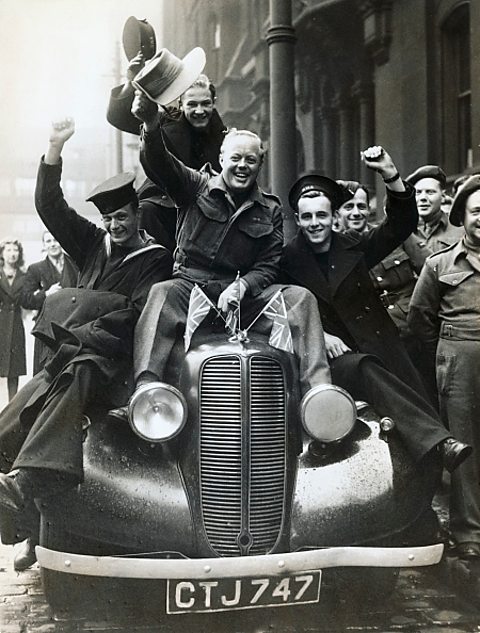 Soldiers on leave celebrate VE Day in a car