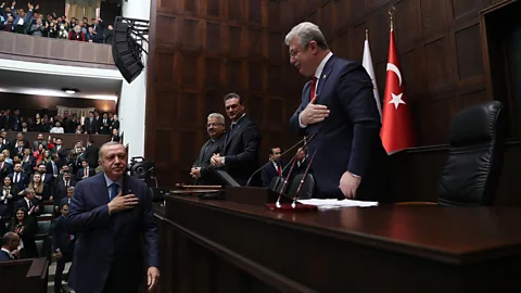 Anadolu Agency/Getty Images Since the pandemic, many Turks have revived the centuries-old eyvallah greeting, where one puts a hand over their heart and bows slightly (Credit: Anadolu Agency/Getty Images)