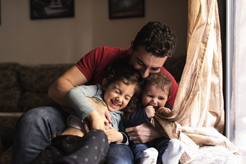 Father laughing with his children