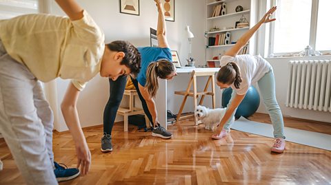 A family doing yoga at home