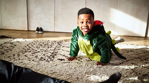 A boy in a lizard costume