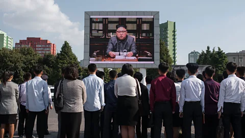 Getty Images Spectators watching a statment by North Korean leader Kim Jong-Un (Credit: Getty Images)