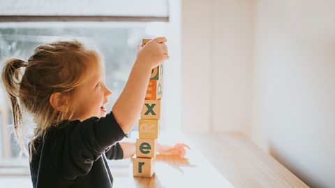 A child stacking blocks 