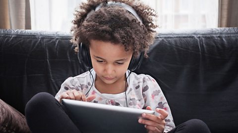 A child playing on their tablet