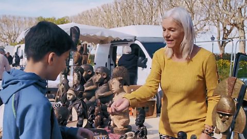 Garrett buying a bracelet from a lady on one of the stalls at the flea market