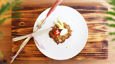 Bord För En The first course is a Swedish-style hash browns with thick sour cream (Credit: Bord För En)