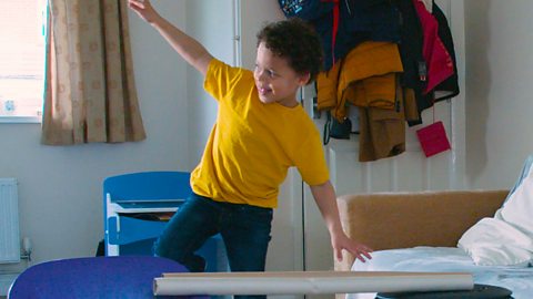 A boy balancing on one leg.