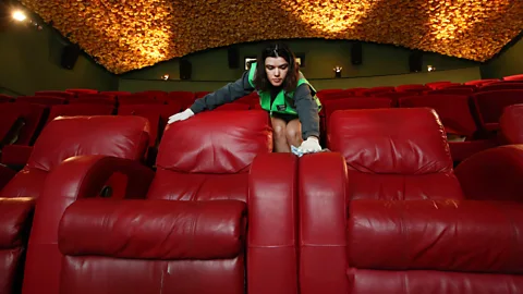 Getty Images A cinema is cleaned and prepared for guests in Auckland, New Zealand; as people return to social spaces, they want to feel safe and secure (Credit: Getty Images)