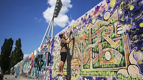 Tom Stoddart/Getty Images Want to grab a spray can and tag the Berlin Wall on a nice day? Sure! There's a designated space for that (Credit: Tom Stoddart/Getty Images)