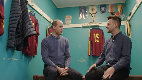 An image of HRH Prince William talking to footballer Matthew in a changing room