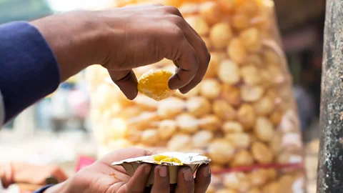 IndiaPictures/Getty Images Pani puri is one of the street snacks that many Indians have missed the most during lockdown (Credit: IndiaPictures/Getty Images)