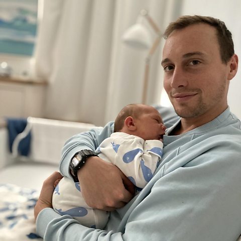 Mark holding baby Albert in hospital.