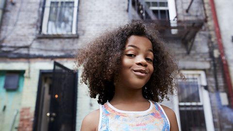 Child gives knowing look to camera