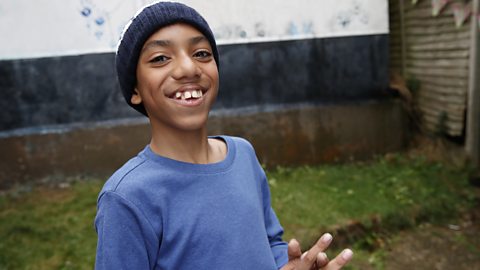 Smiling boy looks happily to camera