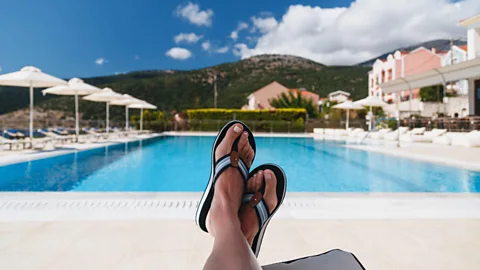 Stock image of a woman’s feet by a pool in Greece on 14 July 2019
