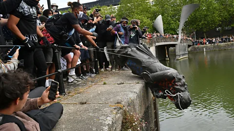 PA Wire Protesters tore down a statue of Edward Colston and threw it into Bristol harbour during a Black Lives Matter rally (Credit: PA Wire)