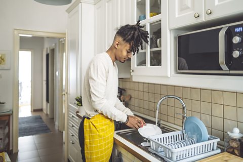 Boy doing the dishes