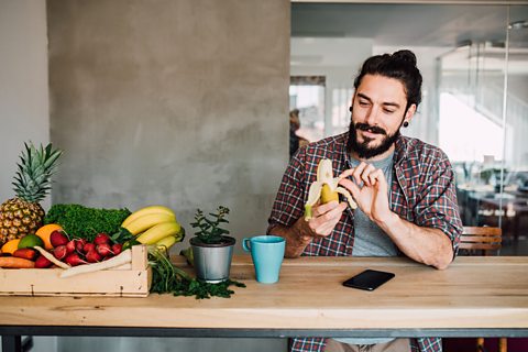 Young boy eating a banana