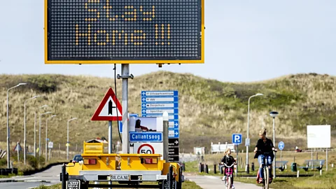 Getty Images A traffic sign in North Holland urging Dutch residents to stay home in April. Throughout Covid-19, the country has been proactive with stay-at-home measures (Credit: Getty Images)