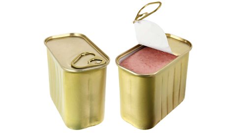 Two tins of tinned ham, one with the lid pulled up. 