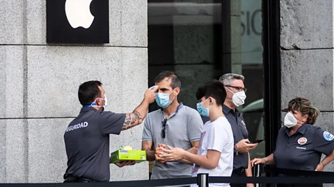 Alamy Touchless temperate checks are among the new standard procedures customers must adjust to in order to return to their favourite shops (Credit: Alamy)