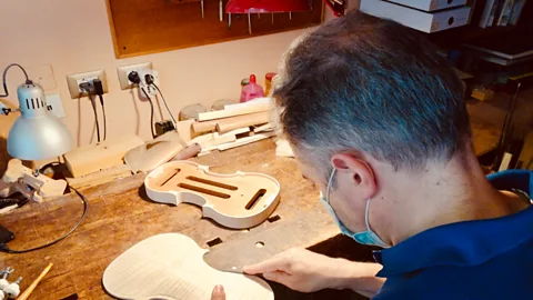 Michela Vado Patrick Orippi working on the back of a violin; he normally makes six or seven instruments a year (Credit: Michela Vado)