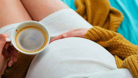 Gety Images Pregnant woman with coffee (Credit: Gety Images)