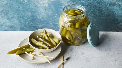 A jar with quick fridge dill pickles in it