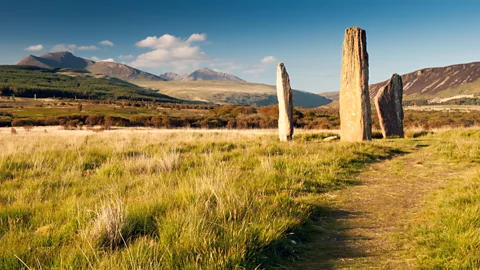 Joe Dunckley/Getty Images Documented human activity on the Isle of Arran dates as far back as 10,000 years, including these Bronze Age stone circles (Credit: Joe Dunckley/Getty Images)