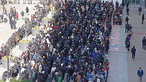 Alamy People queued for hours to buy face masks during Korea's lockdown (credit: Alamy)