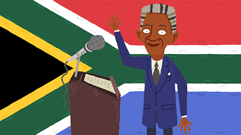 Cartoon Nelson Mandela as old man with microphone in front of South African flag, waving