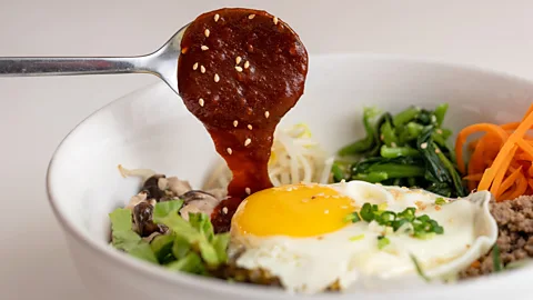Justin Ong/Getty Images Gochujang brings heat to famous Korean dishes like bibimbap (Credit: Justin Ong/Getty Images)