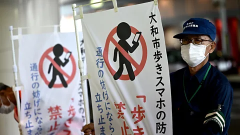 Getty Images Yamato has become the first Japanese city to ban people using smartphones while walking (credit: Getty Images)