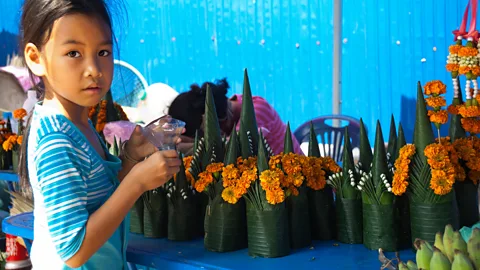 Anne-Marie Palmer/Alamy A flower montage made of banana leaves and French marigolds is part of the baci ceremony (Credit: Anne-Marie Palmer/Alamy)