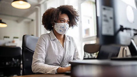 Getty Images File image of masked worker in an office