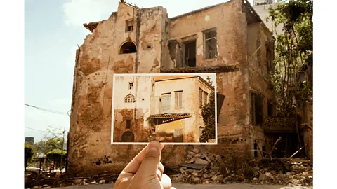 Joseph M Khoury A new series of photographs shows Khoury and Cardozo holding up their postcards in front of the structures shattered by the explosion (Credit: Joseph M Khoury)