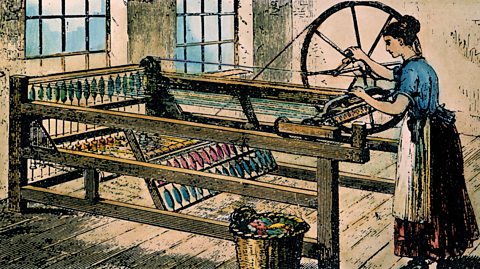 A woman operating a spinning jenny in a factory